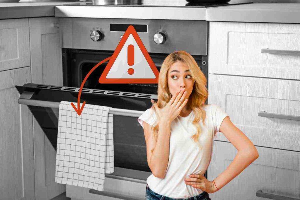 strofinaccio appeso al forno, segnale di pericolo e donna preoccupata