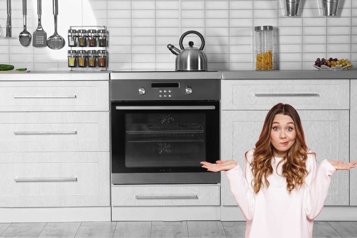 un forno con il cassetto sotto e una ragazza dubbiosa